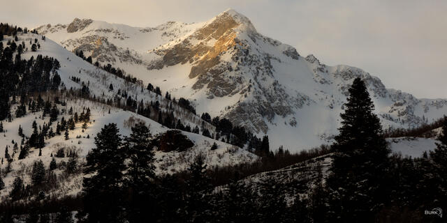 Alpenglow on winter snow mountain.