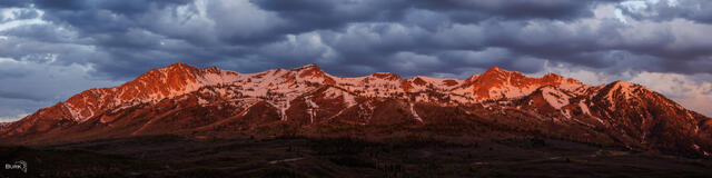 An Alpenglow hits the mountain of Snow Basin Resort at sunrise. 