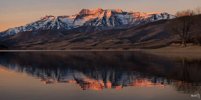 Mount Timpanogos alpenglow at sunrise at deer creek reservoir 