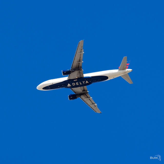 A Delta Air Lines Airbus A220 photographed in flight over Salt Lake City, Utah, as it made its approach to Salt Lake City International Airport.