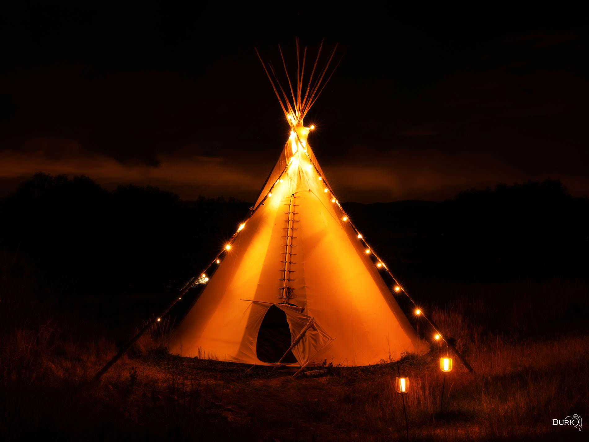 Tipi Dreams moody lit tipi at night time.