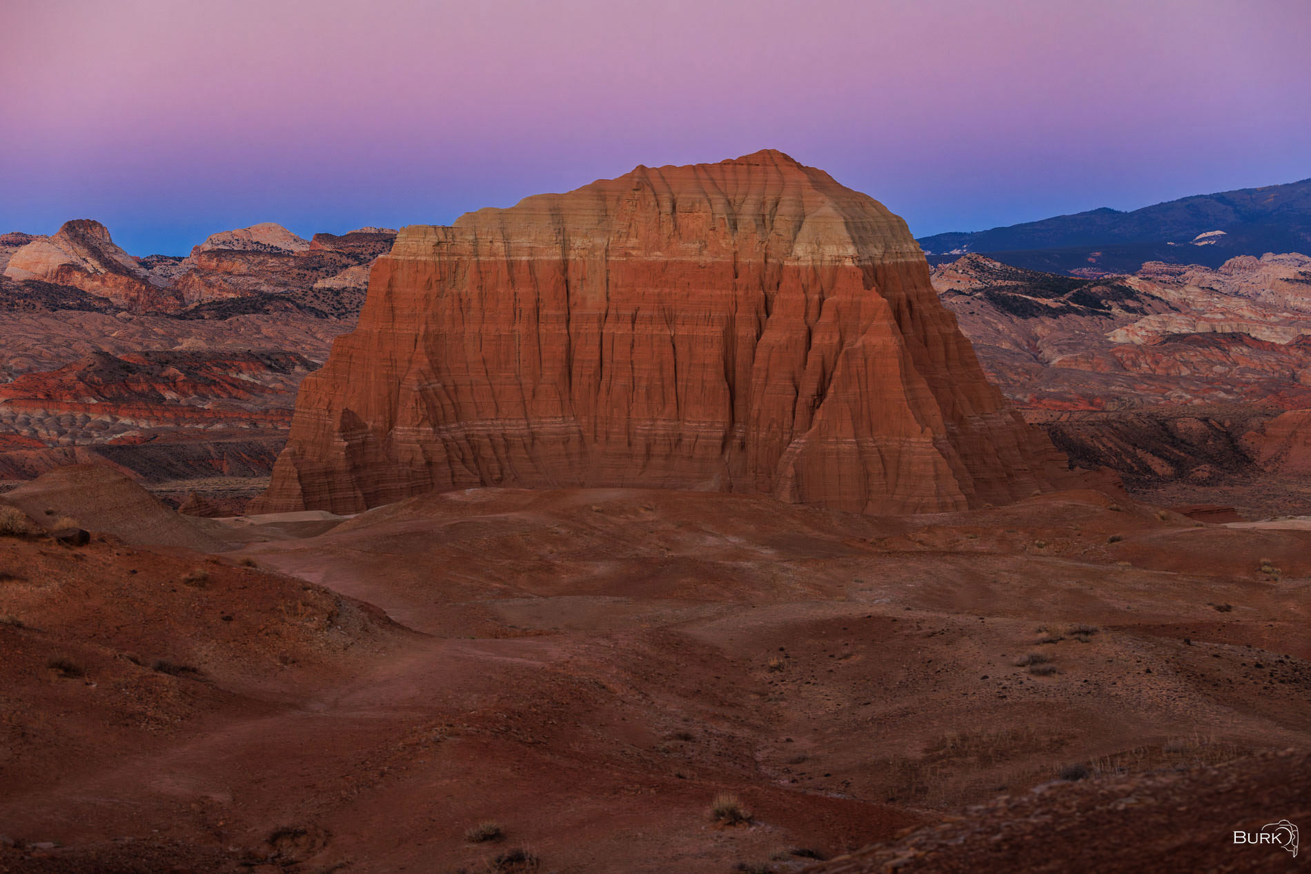 Sunrise at Jailhouse Rock Jailhouse Rock is made of reddish Entrada Sandstone, topped by a tough gray-green cap of sandstone and siltstone from the Curtis...